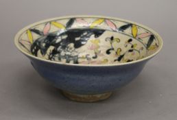 A Chinese porcelain bowl decorated with lotus bloom in pink, yellow and blue. 17 cm diameter.