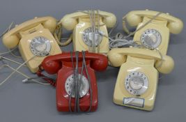 A box of vintage telephones.