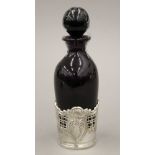 A silver mounted amethyst glass scent bottle. 16.5 cm high.