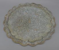 An Eastern pierced brass tray. 60 cm diameter.