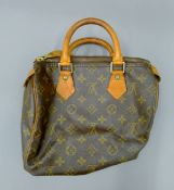 A Louis Vuitton Speedy 25, Made in France 1995, serial number SP0975, with padlock and certificate.