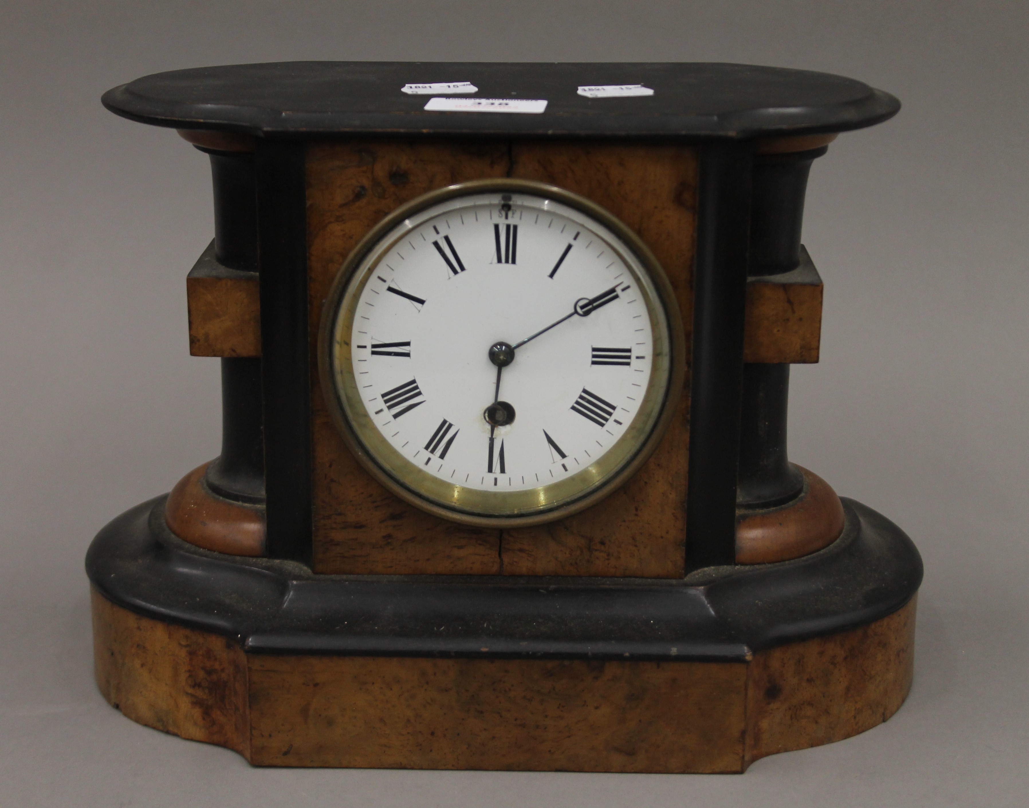 A Victorian walnut mantle clock. 30 cm wide.
