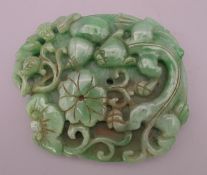A jade disc with dragon and bats. 10 cm wide.