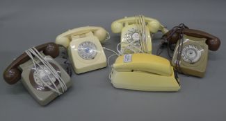 A box of vintage telephones.