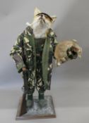 A taxidermy specimen of a Red fox Vulpes vulpes dressed as a gamekeeper. 106 cm high.