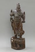 An Oriental carved hardwood figure of a warrior. 78 cm high.