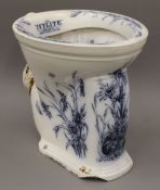 A Victorian blue and white toilet bowl with floral decoration.