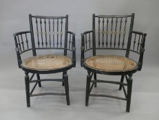 A pair of Regency cane seated armchairs, in original paint. Each 51 cm wide.