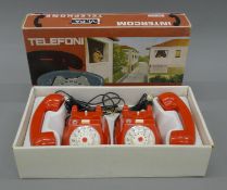 A boxed pair of intercom telephones.