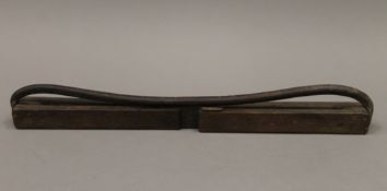 A vintage wooden and leather game hanger. 47 cm long.