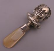 A Victorian silver and mother-of-pearl rattle formed as a child's head. 11.5 cm high.