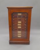 A Victorian mahogany glazed front twelve drawer insect collectors cabinet by Watkins and Doncaster.