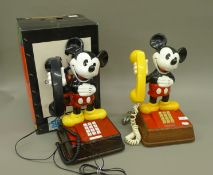 Two Mickey Mouse telephones, one boxed. 38.5 cm high.