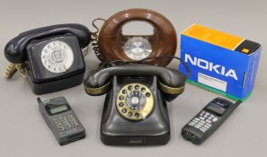 A box of vintage telephones.