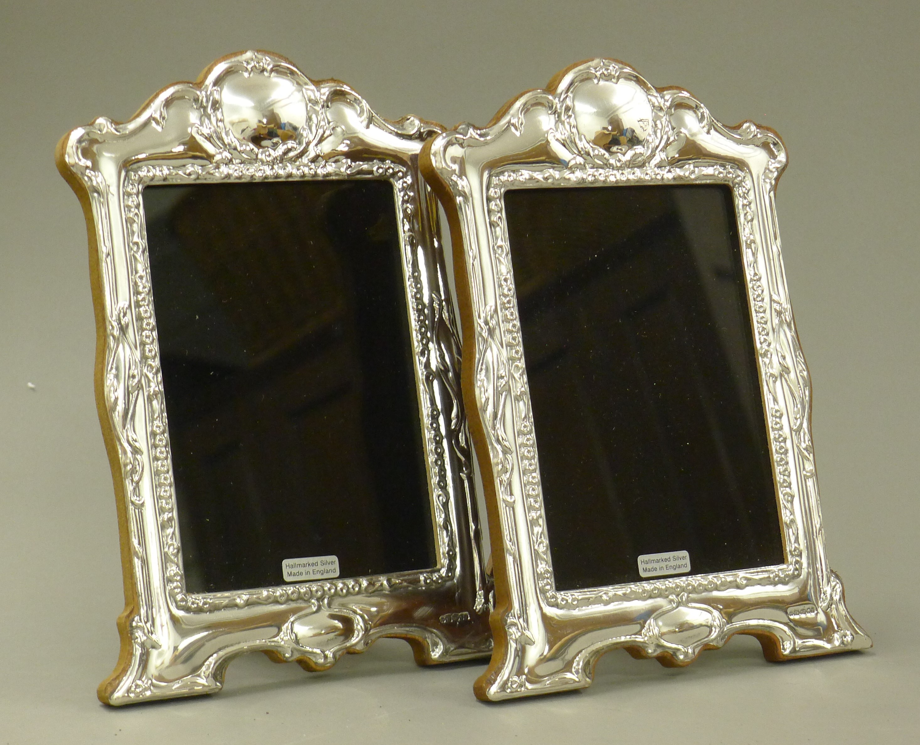 A pair of silver photograph frames.