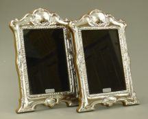 A pair of silver photograph frames.