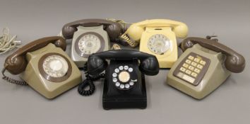 A box of vintage telephones.