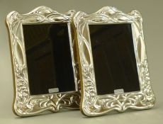 A pair of silver photograph frames.