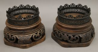 A pair of large Chinese wooden and bronze stands. 28 cm diameter.