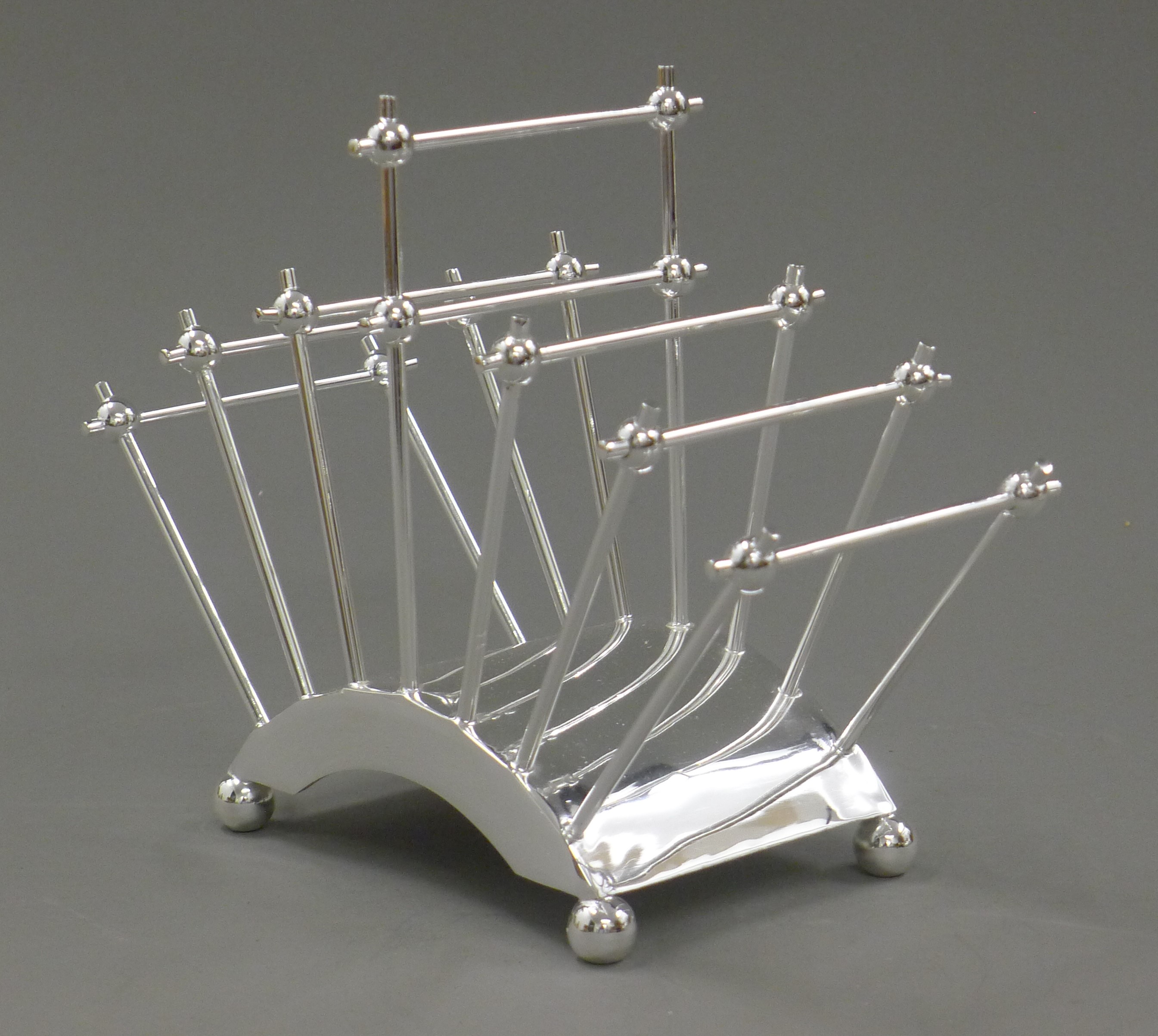 A Christopher Dresser style silver plated toast rack. 22 cm long. - Image 2 of 3