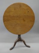 An 18th century oak tripod table. 71 cm diameter.