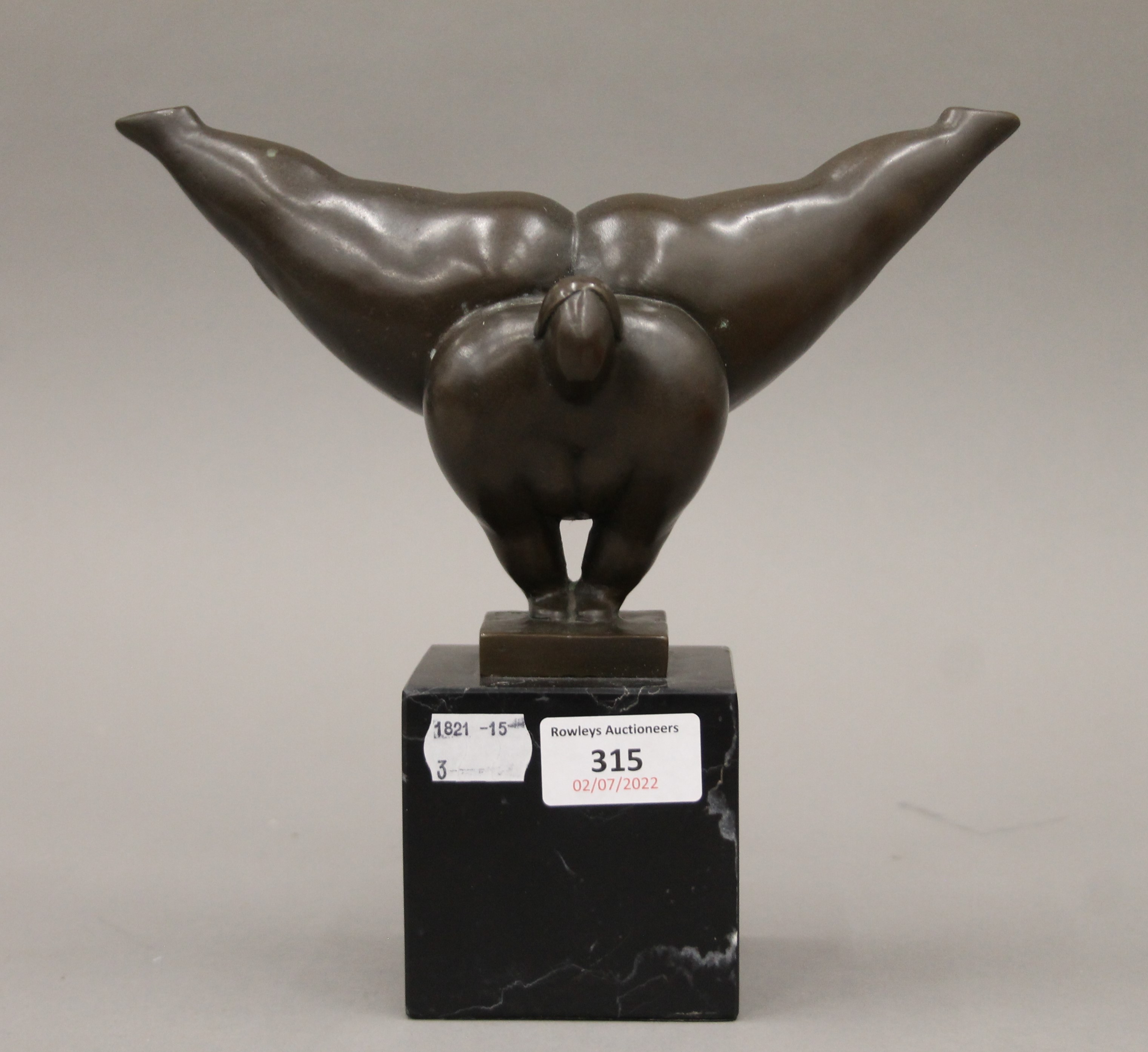 A bronze model of an acrobatic nude. 22 cm high.
