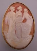 An antique 9 ct gold carved cameo brooch depicting three classical figures. 5 cm high.