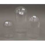 Two glass domes and a plastic dome. The glass domes 25 cm high and 14 cm high.