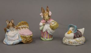 Three Beatrix Potter figurines; Mrs Rabbit, Hunca Munca and Jemima Puddleduck.