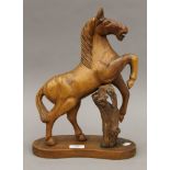 A carved walnut model of a rearing horse, possibly Blackforest. 37 cm high.