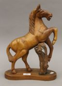 A carved walnut model of a rearing horse, possibly Blackforest. 37 cm high.