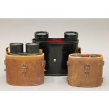 Three cased pairs of binoculars.