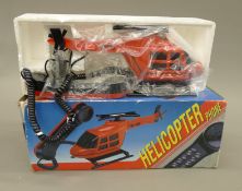 A boxed helicopter novelty telephone.