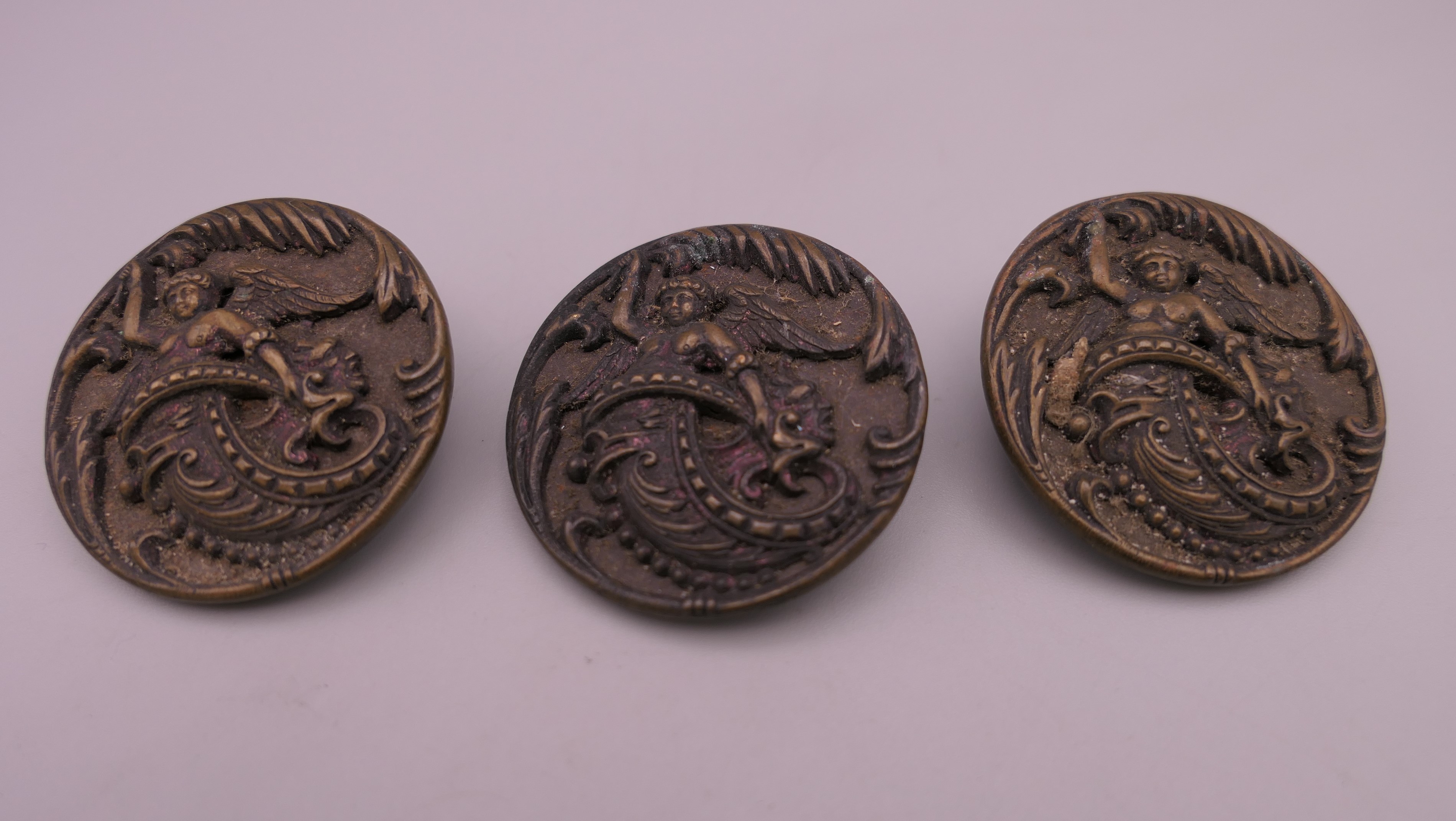 Three Victorian ornate buttons. 3.5 cm diameter.