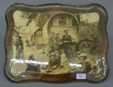 A wall plaque depicting gypsy encampment. 43.5 cm wide.