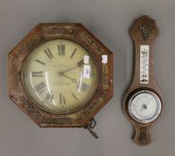 A brass inlaid postman's alarm clock and a barometer.