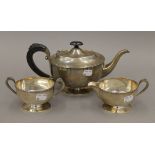 A silver tea set. The tea pot 28 cm long. 847.5 grammes total weight.