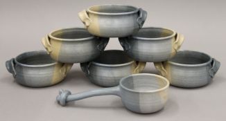 A quantity of Studio Pottery soup bowls and a ladle.