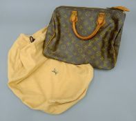A Louis Vuitton Speedy 30, Made in Italy, stamped SA, with dust bag. 31 x 21 x 19 cm.