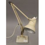 A vintage cream painted anglepoise lamp.