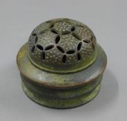 A bronze pierced top lidded censer. 8 cm high.