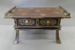 A 19th century Japanese lacquered low table. 36 cm high x 61 cm long.