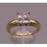 An 18 K gold four stone diamond ring. Ring size T/U. 6.6 grammes total weight.
