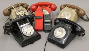 A box of vintage telephones.