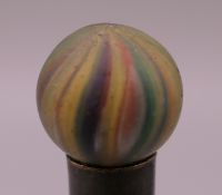An onion skin glass marble. 11/16th of a inch diameter.