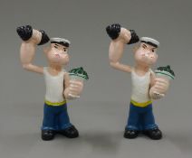 Two cast iron Popeye figures. Each 15.5 cm high.