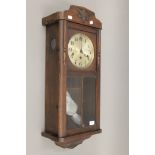 A late 19th/early 20th century oak Vienna wall clock. 77 cm high.
