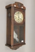 A late 19th/early 20th century oak Vienna wall clock. 77 cm high.