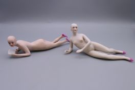 Two 19th century Continental bisque porcelain models of naked ladies, one reading a book.