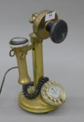 A brass candlestick telephone. 31 cm high.